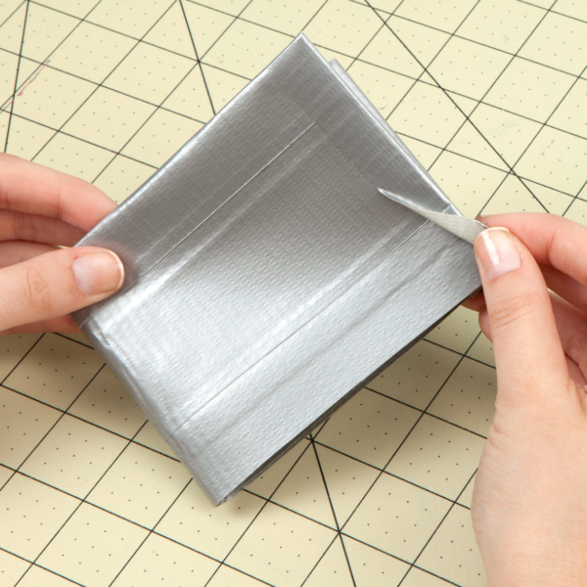 fold the wallet in half and secure the other end with tape to hold it in a wallet shape