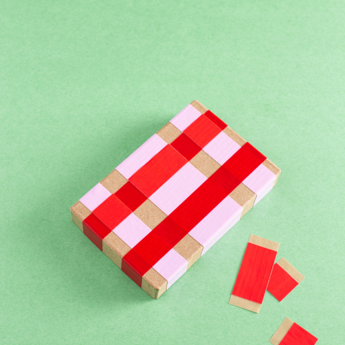 Squares of tape used to fill in areas where the strips of tape overlap on the box